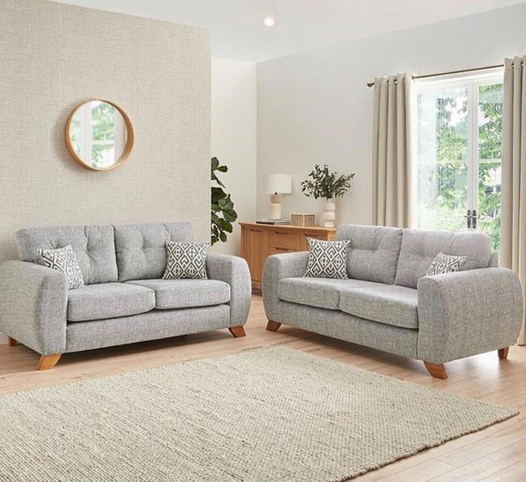 Two grey fabric sofas in a living room